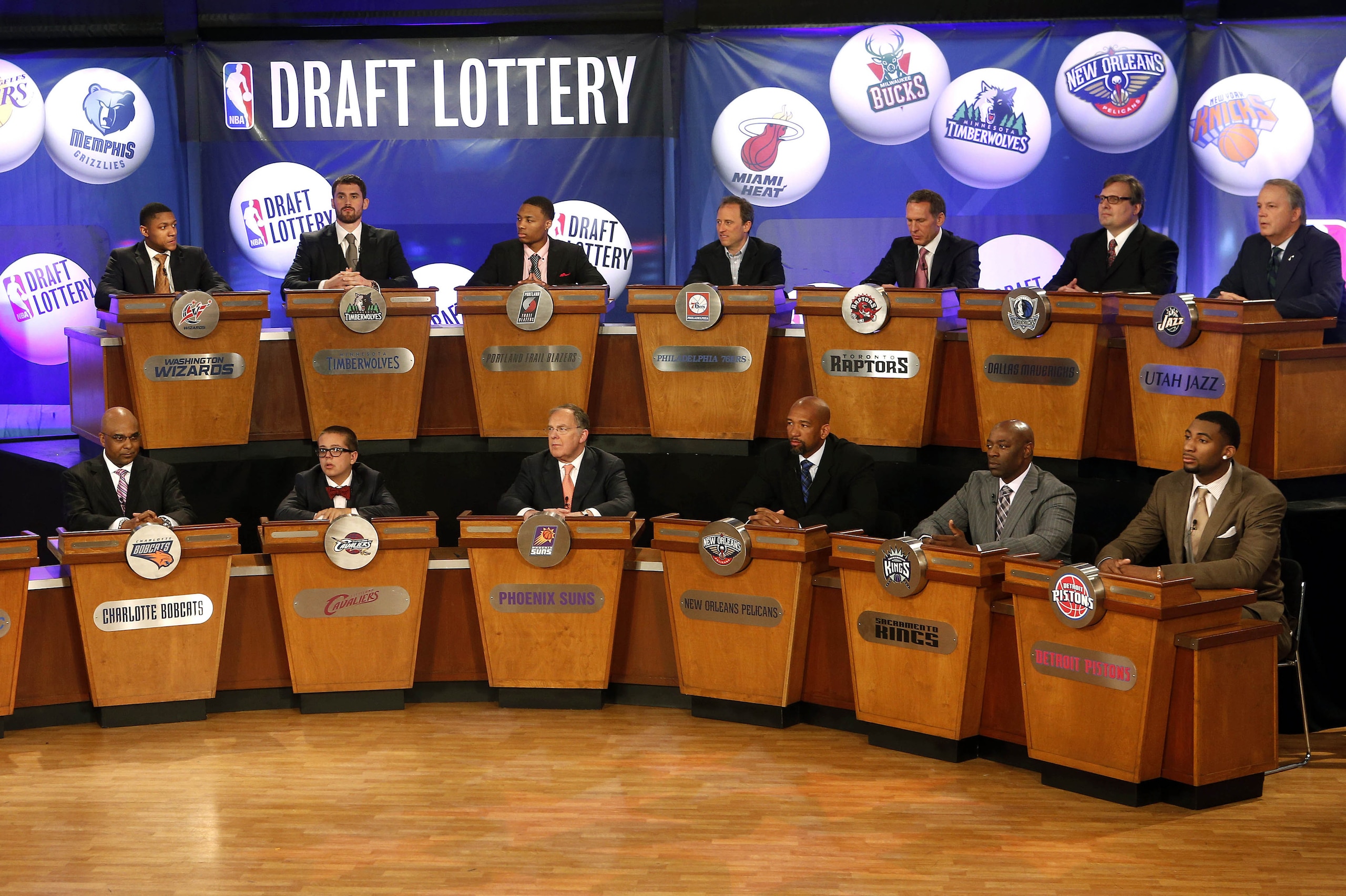 FILE - In this May 21, 2013 file photo, NBA basketball team representatives sit onstage at the start of the NBA draft lottery in New York. The draft lottery is Tuesday, May 20, 2014, a night some teams appeared to be aiming toward for months during a season featuring plenty of talking about tanking. The winner gets the No. 1 pick in next month's draft, when an Andrew Wiggins or Jabari Parker might make all of this season's misery worth it. (AP Photo/Jason DeCrow, File)