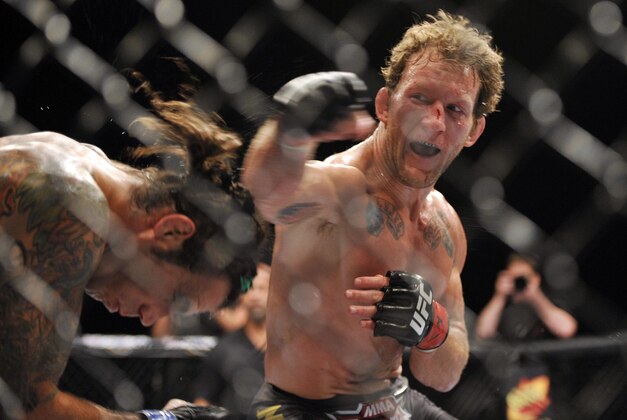 Jun 22, 2012; Atlantic City, NJ, USA; Clay Guida (left) fights Gray Maynard in a lightweight bout during UFC on FX at Revel Resort and Casino. Gray Maynard won the fight by split decision in the fifth round.  Mandatory Credit: Joe Camporeale-USA TODAY Sports