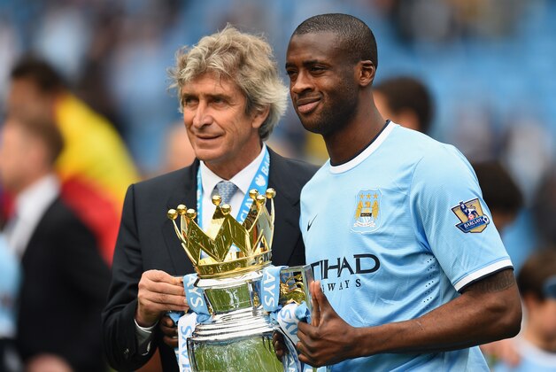 MANCHESTER, ENGLAND - MAY 11:  The Manchester City Manager Manuel Pellegrini and Yaya Toure pose with the trophy at the end of the Barclays Premier League match between Manchester City and West Ham United at the Etihad Stadium on May 11, 2014 in Manchester, England.  (Photo by Shaun Botterill/Getty Images)