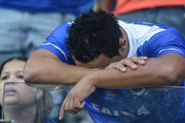 BELO HORIZONTE, BRAZIL - MAY 14: Fans of Cruzeiro react following a match between Cruzeiro and San Lorenzo as part of Copa Bridgestone Libertadores 2014 Quarter Final at Mineirao stadium on May 14, 2014 in Belo Horizonte, Brazil.  (Photo by Pedro Vilela/Getty Images)
