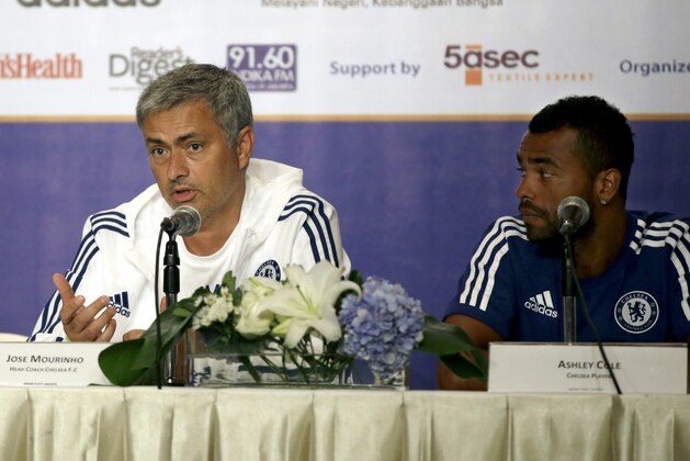 Chelsea's manager Jose Mourinho, left, speaks to the media as player Ashley Cole listens during a press conference in Jakarta, Indonesia, Tuesday, July 23, 2013. Chelsea is scheduled to play against Indonesia on Thursday in a friendly match as part of their Asia Tour 2013. (AP Photo/Dita Alangkara)