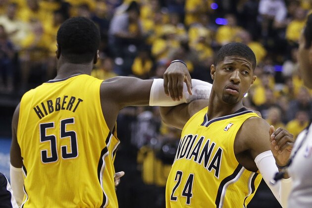 Indiana Pacers' Roy Hibbert (55) and Paul George celebrate during the second half of Game 1 of the Eastern Conference finals NBA basketball playoff series, Sunday, May 18, 2014, in Indianapolis. Indiana defeated Miami 107-96. (AP Photo/Darron Cummings)