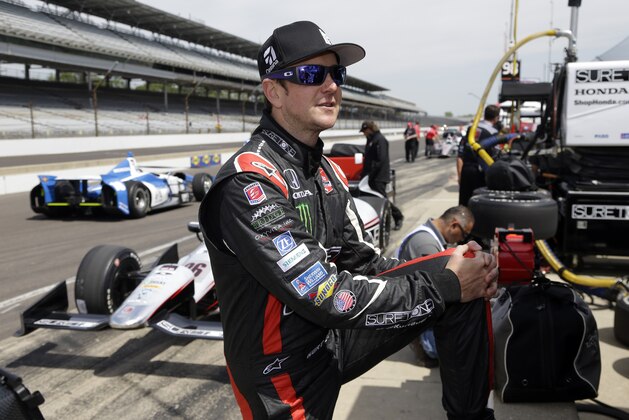 Kurt Busch stretches before the start of practice for the Indianapolis 500 IndyCar auto race at the Indianapolis Motor Speedway in Indianapolis, Monday, May 19, 2014. (AP Photo/Michael Conroy)