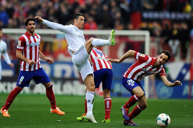 MADRID, SPAIN - MARCH 02:  Cristiano Ronaldo (L) of Real Madrid CF battles for tha ball against Juan Francisco Torres alias Juanfran of Club Atletico de Madrid during the La Liga match between Club Atletico de Madrid and Real Madrid CF  at Vicente Calderon Stadium on March 2, 2014 in Madrid, Spain.  (Photo by Denis Doyle/Getty Images)
