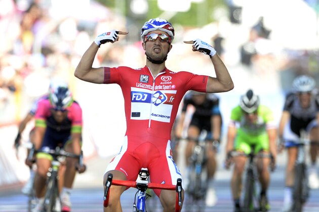 France's Nacer Bouhanni celebrates as he cuts the finish line to win the 10th stage of the Giro d'Italia, Tour of Italy cycling race, from Modena to Salso Maggiore, Italy, Tuesday, May 20, 2014. (AP Photo/Fabio Ferrari)