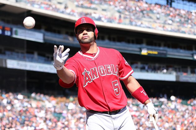 DETROIT, MI - APRIL 19: Albert Pujols #5 of the Los Angeles Angels of Anaheim tosses a baseball to a fan during the ninth inning of the game against the  Detroit Tigers at Comerica Park on April 19, 2014 in Detroit, Michigan. The Tigers defeated the Angels 5-2.  (Photo by Leon Halip/Getty Images)