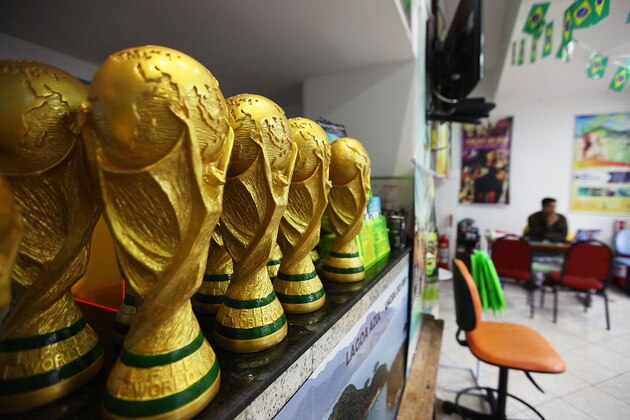 RIO DE JANEIRO, BRAZIL - MAY 19: Replica 2014 FIFA World Cup trophies are displayed in a travel agency which caters to tourists on May 19, 2014 in Rio de Janeiro, Brazil.  Brazil is gearing up to host 600,000 foreign tourists for the 2014 FIFA World Cup which kicks off June 12.  (Photo by Mario Tama/Getty Images)