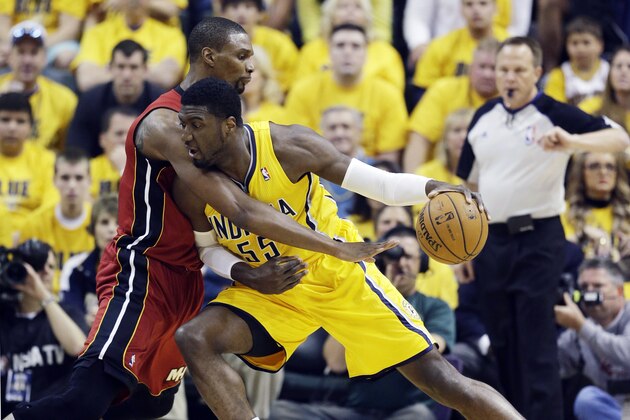Indiana Pacers center Roy Hibbert (55) drives against Miami Heat center Chris Bosh during the first half of Game 1 of the Eastern Conference finals NBA basketball playoff series, Sunday, May 18, 2014, in Indianapolis. (AP Photo/Darron Cummings)