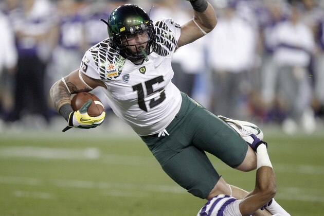 FILE - In this Jan. 3, 2013, file photo, Oregon's Colt Lyerla runs against Kansas State's Jarard Milo during the Fiesta Bowl NCAA college football game in Glendale, Ariz. The second-ranked Oregon Ducks didn’t appear to lose a step when they lost star running back De’Anthony Thomas to an ankle injury, and they don’t expect to be impacted much by the departure of tight end Lyerla .(AP Photo/Paul Connors, file)