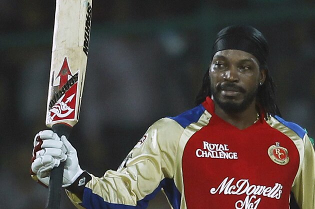 Chris Gayle of Royal Challengers Bangalore raises his bat after scoring a century during their IPL cricket match against Delhi Daredevils, in New Delhi, India, Thursday, May 17, 2012. (AP Photo/ Saurabh Das)