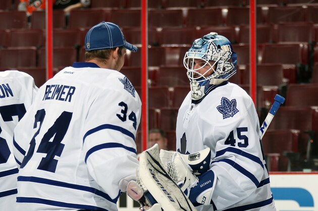 PHILADELPHIA, PA - OCTOBER 02:  Jonathan Bernier #45 of the Toronto Maple Leafs celebrates with James Reimer #34 after defeating the Philadelphia Flyers 3-1 on October 2, 2013 at the Wells Fargo Center in Philadelphia, Pennsylvania.  (Photo by Len Redkoles/NHLI via Getty Images)