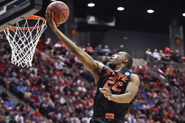 Oklahoma State guard Markel Brown sails to the basket for a score against Gonzaga during the second half in a second-round game in the NCAA college basketball tournament Friday, March 21, 2014, in San Diego. (AP Photo/Denis Poroy)