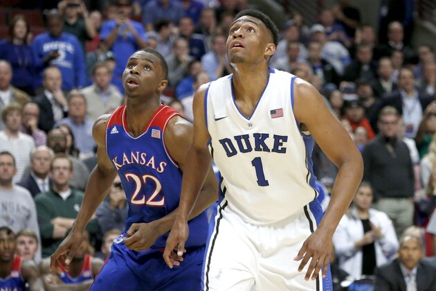 Duke forward Jabari Parker and Kansas guard Andrew Wiggins look for a possible rebound off a free-throw attempt during the second half of an NCAA college basketball game Tuesday, Nov. 12, 2013, in Chicago. Kansas won 94-83. (AP Photo/Charles Rex Arbogast)