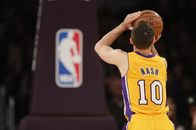 Los Angeles Lakers guard Steve Nash shoots a free throw as the NBA logo can be seen below the basket against the Portland Trail Blazersduring the first half of an NBA basketball game in Los Angeles, Tuesday, April 1, 2014. (AP Photo/Danny Moloshok)