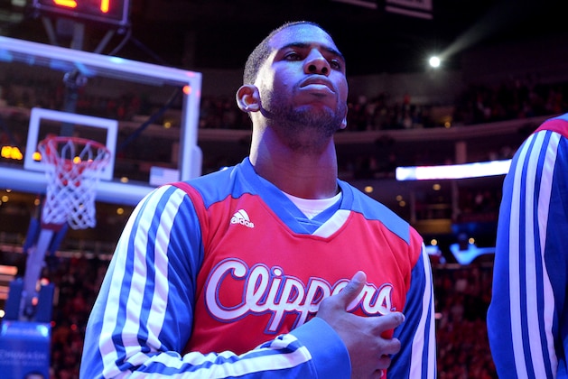 LOS ANGELES, CA - DECEMBER 22: Chris Paul #3 of the Los Angeles Clippers stands in observance of the national anthem before a game against the Minnesota Timberwolves at STAPLES Center on December 22, 2013 in Los Angeles, California. NOTE TO USER: User expressly acknowledges and agrees that, by downloading and/or using this Photograph, user is consenting to the terms and conditions of the Getty Images License Agreement. Mandatory Copyright Notice: Copyright 2013 NBAE (Photo by Andrew D. Bernstein/NBAE via Getty Images)