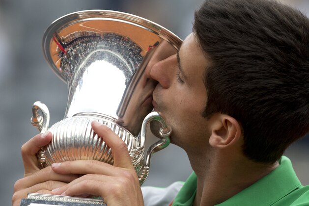 Serbia's Novak Djokovic kisses the trophy after defeating Spain's Rafael Nadald at the final match of the Italian Open tennis tournament, in Rome, Sunday, May 18, 2014. Novak Djokovic extended his recent dominance over Rafael Nadal by rallying for a 4-6, 6-3, 6-3 victory Sunday to win the Italian Open for the third time. (AP Photo/Andrew Medichini)