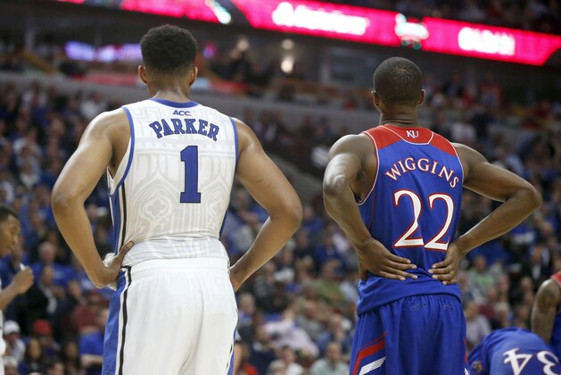 Duke forward Jabari Parker (1) and Kansas guard Andrew Wiggins (22) wait for a free throw during the second half of an NCAA college basketball game Tuesday, Nov. 12, 2013, in Chicago. Kansas won 94-83. (AP Photo/Charles Rex Arbogast)