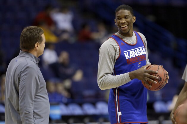 Kansas' Joel Embiid, right, talks with head coach Bill Self during practice for the NCAA college basketball tournament Thursday, March 20, 2014, in St. Louis. Kansas is scheduled to play Eastern Kentucky in a second-round game on Friday. (AP Photo/Jeff Roberson)