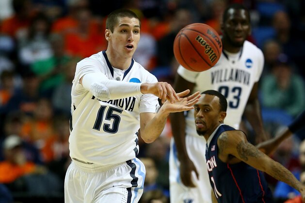 BUFFALO, NY - MARCH 22: Ryan Arcidiacono #15 of the Villanova Wildcats passes the ball as Ryan Boatright #11 of the Connecticut Huskies defends during the third round of the 2014 NCAA Men's Basketball Tournament at the First Niagara Center on March 22, 2014 in Buffalo, New York.  (Photo by Elsa/Getty Images)