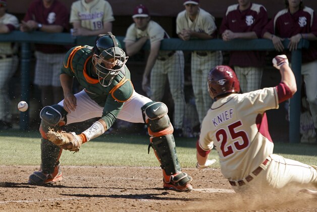 Miami catcher Garrett Kennedy (40) can't hold onto the throw as Florida State's Brett Knief (25) scores in the sixth inning of an NCAA college baseball game on Sunday, March 2, 2014, in Tallahassee, Fla. Florida State won 13-6. (AP Photo/Phil Sears)
