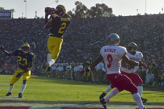 Michigan's cornerback Charles Woodson (2) leaps to make an interception in the end zone in the first half on a pass from Washington State's Ryan Leaf during the 84th Rose Bowl in Pasadena, Calif., Thursday, Jan. 1, 1998. Watching the play are Michigan's William Peterson (23) and Washington States Kevin McKenzie (9). Player at right unidentified. (AP Photo/Mark J. Terrill)