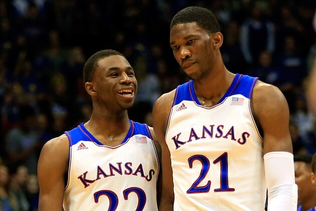 LAWRENCE, KS - NOVEMBER 22: Andrew Wiggins #22 of the Kansas Jayhawks talks with Joel Embiid #21 as they walk onto the floor after a timeout during the game against the Towson Tigers at Allen Fieldhouse on November 22, 2013 in Lawrence, Kansas. (Photo by Jamie Squire/Getty Images)