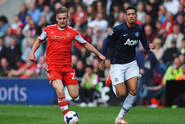 SOUTHAMPTON, ENGLAND - MAY 11:  (L-R) Luke Shaw of Southampton holds off Chris Smalling of Manchester United during the Barclays Premier League match between Southampton and Manchester United at St Mary's Stadium on May 11, 2014 in Southampton, England.  (Photo by Mike Hewitt/Getty Images)