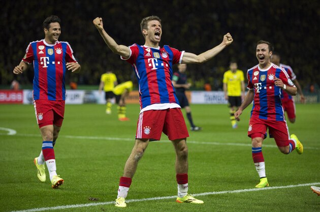 Bayern's Thomas Mueller, center, celebrates scoring his side's second goal during the German Soccer Cup Final between FC Bayern Munich and Borussia Dortmund at the Olympic Stadium in Berlin, Germany, Saturday, May 17, 2014. (AP Photo/Gero Breloer)