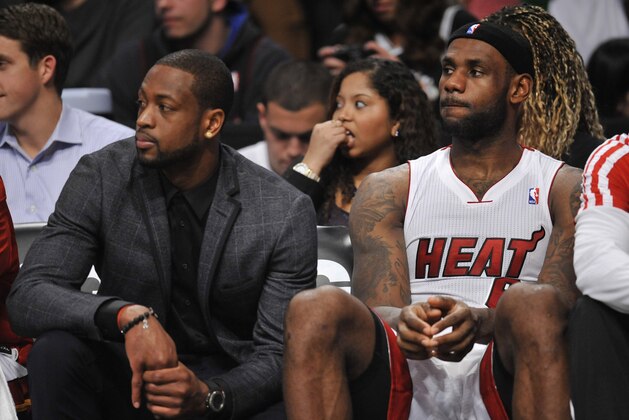 Jan 10, 2014; Brooklyn, NY, USA; Miami Heat small forward LeBron James (6) and shooting guard Dwyane Wade (suit) look on against the Brooklyn Nets during the second overtime at Barclays Center. The Brooklyn Nets won the game 104-95 in double overtime. Mandatory Credit: Joe Camporeale-USA TODAY Sports