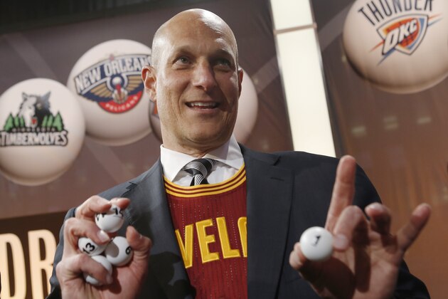 Cleveland Cavaliers minority owner Jeff Cohen displays the ping pong ball that won the Cavaliers the top pick during the NBA draft lottery in New York, Tuesday, May 20, 2014.  (AP Photo/Kathy Willens)