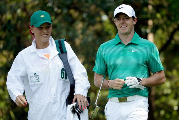 AUGUSTA, GA - APRIL 09:  Rory McIlroy of Northern Ireland alongside his caddie/girlfriend Caroline Wozniacki during the 2014 Par 3 Contest prior to the start of the 2014 Masters Tournament at Augusta National Golf Club on April 9, 2014 in Augusta, Georgia.  (Photo by Ezra Shaw/Getty Images for Golfweek)