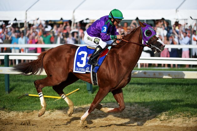 BALTIMORE, MD - MAY 17:  California Chrome #3, ridden by Victor Espinoza, races during the 139th running of the Preakness Stakes at Pimlico Race Course on May 17, 2014 in Baltimore, Maryland.  (Photo by Molly Riley/Getty Images)