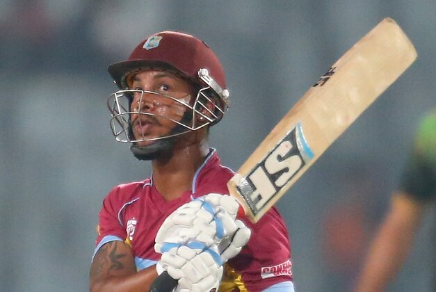 DHAKA, BANGLADESH - APRIL 01:  Lendl Simmons of the West Indies bats as Kamran Akmal of Pakistan looks on during the ICC World Twenty20 Bangladesh 2014 match between West Indies and Pakistan at Sher-e-Bangla Mirpur Stadium on April 1, 2014 in Dhaka, Bangladesh.  (Photo by Scott Barbour/Getty Images)