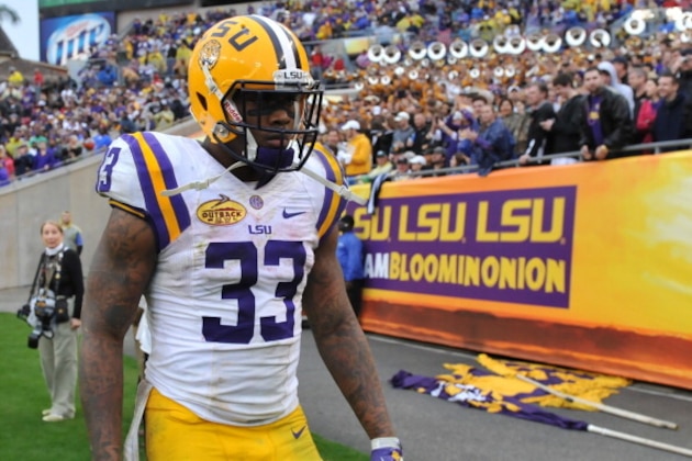 TAMPA, FL -  JANUARY 1:  Running back Jeremy Hill #33 of the LSU Tigers elks to the team bench after running for a 2nd-half touchdown against the Iowa Hawkeyes January 1, 2014  in the Outback Bowl at Raymond James Stadium in Tampa, Florida.  LSU won 21 - 14. (Photo by Al Messerschmidt/Getty Images)
