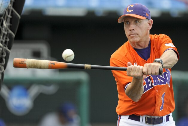 FILE - In this file photo from June 8, 2010 Clemson coach Jack Leggett hits the ball during team practice at Rosenblatt Stadium in Omaha, Neb. With the college game on pace to set a record for fewest home runs and a 40-year low for scoring and batting average, Leggett is leading the push to put a more lively ball into play to bring the numbers back up.(AP Photo/Eric Francis)