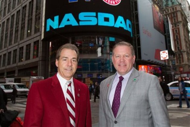 In this photo provided by NASDAQ, University of Alabama head football coach Nick Saban, left, poses with Notre Dame head football coach Brian Kelly outside of the NASDAQ MarketSite in New York, Wednesday, Dec. 5, 2012. (AP Photo/NASDAQ, Zef Nikolla)