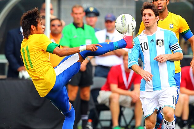 EAST RUTHERFORD, NJ - JUNE 9: Neymar #11 of Brazil kicks the ball as Lionel Messi #10 of Argentina closes in during the second half of an international friendly soccer match on June 9, 2012 at MetLife Stadium in East Rutherford, New Jersey. Argentina defeated Brazil 4-3. (Photo by Rich Schultz/Getty Images) EAST RUTHERFORD, NJ - JUNE 9: Neymar #11 of Brazil kicks the ball as Lionel Messi #10 of Argentina closes in during the second half of an international friendly soccer match on June 9, 2012 at MetLife Stadium in East Rutherford, New Jersey. Argentina defeated Brazil 4-3. (Photo by Rich Schultz/Getty Images)
