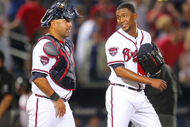 Atlanta Braves starting pitcher Julio Teheran talks with catcher Gerald Laird at the end of a baseball game against the Milwaukee Brewers Tuesday, May 20, 2014, in Atlanta. Teheran pitched a complete game as the Braves won 5-0. (AP Photo/Todd Kirkland)