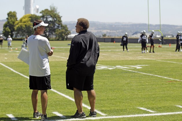 Oakland Raiders head coach Dennis Allen, left, talks to general manager Reggie McKenzie during NFL football practice in Alameda, Calif., Wednesday, June 13, 2012. (AP Photo/Marcio Jose Sanchez)