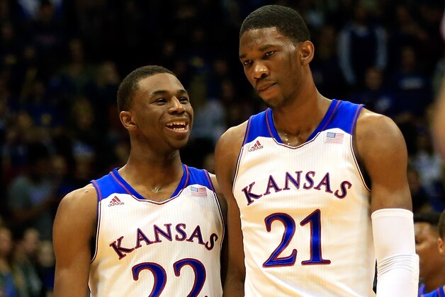 LAWRENCE, KS - NOVEMBER 22: Andrew Wiggins #22 of the Kansas Jayhawks talks with Joel Embiid #21 as they walk onto the floor after a timeout during the game against the Towson Tigers at Allen Fieldhouse on November 22, 2013 in Lawrence, Kansas. (Photo by Jamie Squire/Getty Images)