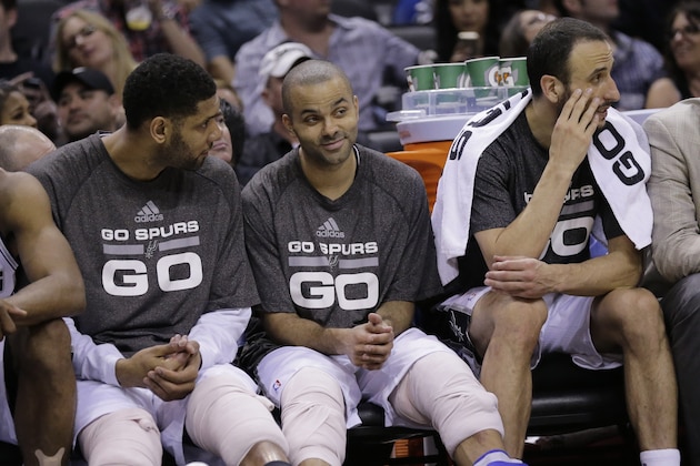 San Antonio Spurs' Tim Duncan, left, Tony Parker, center, and Manu Ginobili, right, sit on the bench during the second half of Game 2 of a Western Conference finals NBA basketball playoff series against the Oklahoma City Thunder, Wednesday, May 21, 2014, in San Antonio. San Antonio won 112-77. (AP Photo/Eric Gay)