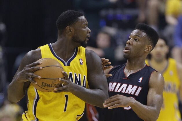 Indiana Pacers' Lance Stephenson is defended by Miami Heat's Norris Cole during the first half of Game 2 of the NBA basketball Eastern Conference finals in Indianapolis, Tuesday, May 20, 2014. (AP Photo/Michael Conroy)