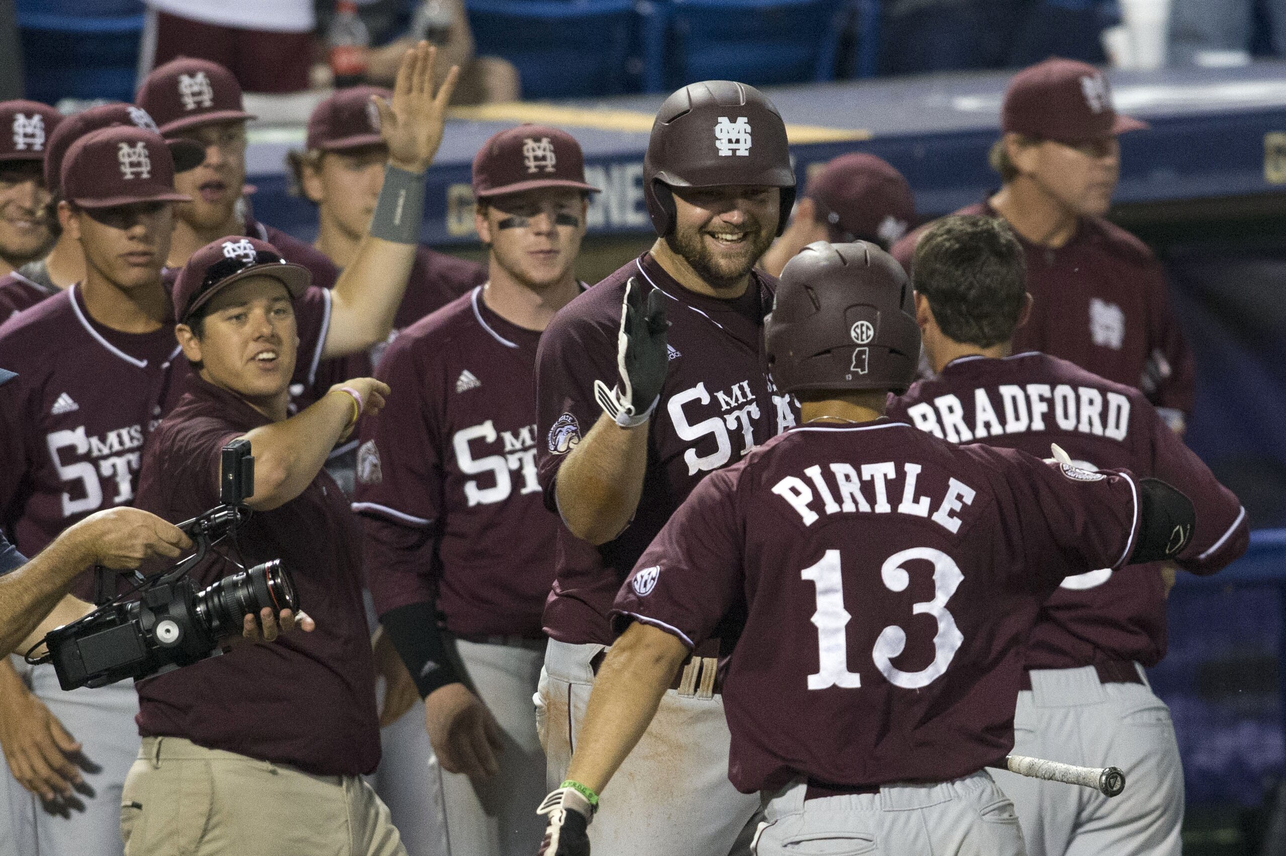 Mississippi State's Wes Rea and teammates greet Brett Pirtle at home after his three-run home run against South Carolina during the Southeastern Conference NCAA college baseball tournament on Wednesday, May 21, 2014, in Hoover, Ala. (AP Photo/Hal Yeager)