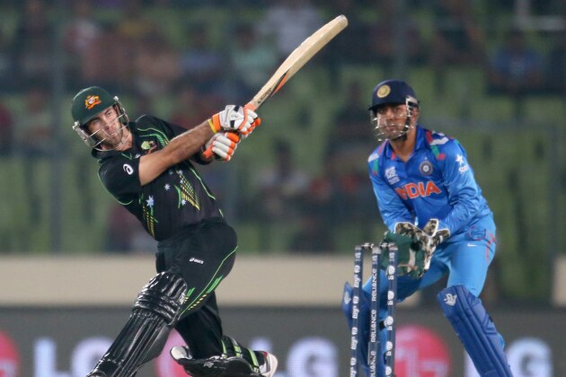 DHAKA, BANGLADESH - MARCH 30:  Glenn Maxwell of Australia hits a six as MS Dhoni of India looks on during the ICC World Twenty20 Bangladesh 2014 match between India v Australia at Sher-e-Bangla Mirpur Stadium on March 30, 2014 in Dhaka, Bangladesh.  (Photo by Scott Barbour/Getty Images)