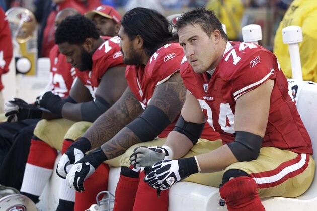 In this Aug. 27, 2011 photo, San Francisco 49ers offensive tackle Joe Staley (74), from right, sits on the bench with guard Mike Iupati (77) and offensive tackle Anthony Davis (76) in the second half of a preseason NFL football game against the Houston Texans in San Francisco. First-year 49ers coach Jim Harbaugh has concerns about his offense as a whole and the shaky line play two weeks ahead of the team's Sept. 11 season opener against the defending NFC West champion Seattle Seahawks. (AP Photo/Paul Sakuma)