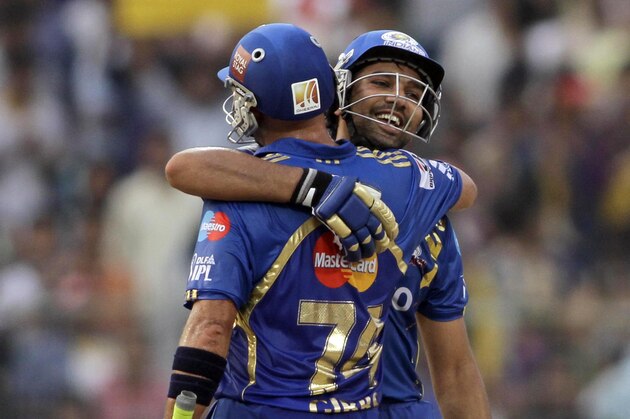 Mumbai Indians' Rohit Sharma, facing camera, is congratulated by teammate Herschelle Gibbs after Sharma scored a century during an Indian Premier League (IPL) cricket match against Kolkata Knight Riders in Kolkata, India, Saturday, May 12, 2012. (AP Photo/Bikas Das)