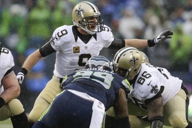 New Orleans Saints quarterback Drew Brees (9) signals at the line of scrimmage during the first half of an NFC divisional playoff NFL football game against the Seattle Seahawks in Seattle, Saturday, Jan. 11, 2014. (AP Photo/John Froschauer)