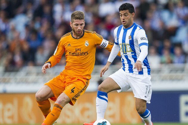 SAN SEBASTIAN, SPAIN - APRIL 05:  Sergio Ramos of Real Madrid CF duels for the ball with Carlos Vela of Real Sociedad during the La Liga match between Real Sociedad and Real Madrid CF at Estadio Anoeta on April 5, 2014 in San Sebastian, Spain.  (Photo by Juan Manuel Serrano Arce/Getty Images)