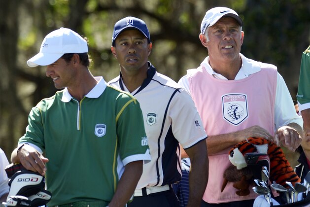 FILE - In this March 14, 2011, file photo, Adam Scott, left, of Australia, and Tiger Woods, center, with caddie Steve Williams wait to take their tee off on the third hole during the first day of the Tavistock Cup golf tournament  in Windermere, Fla. Williams, who has been on the bag for 13 of Woods' major championships, will be working with Adam Scott at Congressional for the 2011 U.S. Open. (AP Photo/Phelan M. Ebenhack, File)