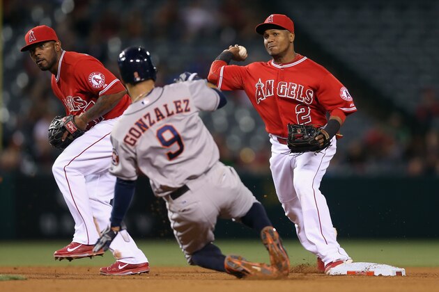 ANAHEIM, CA - MAY 19:  Shortstop Erick Aybar #2 of the Los Angeles Angels of Anaheim forces Marwin Gonzalez #9 of the Houston Astros out at second before throwing to first to complete the double play in the seventh inning at Angel Stadium of Anaheim on May 19, 2014 in Anaheim, California.  (Photo by Jeff Gross/Getty Images)